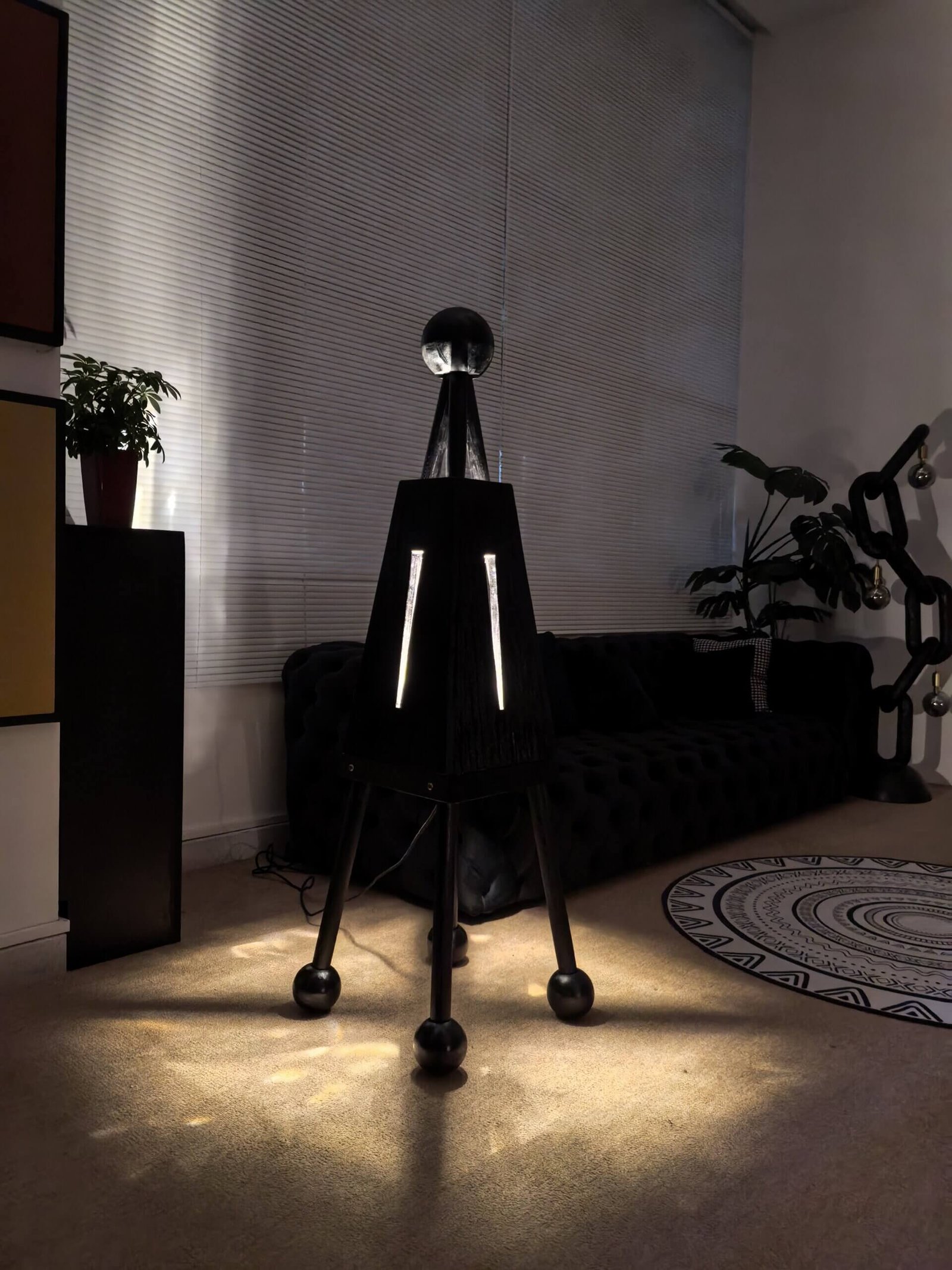 This artistic floor lamp, named Demonlet, is a handmade product crafted from natural solid wood. Its design evokes a European and American medieval style. It is a product of FLOWLIGHT DESIGN INC. and can be found at flowlightdesign.com.