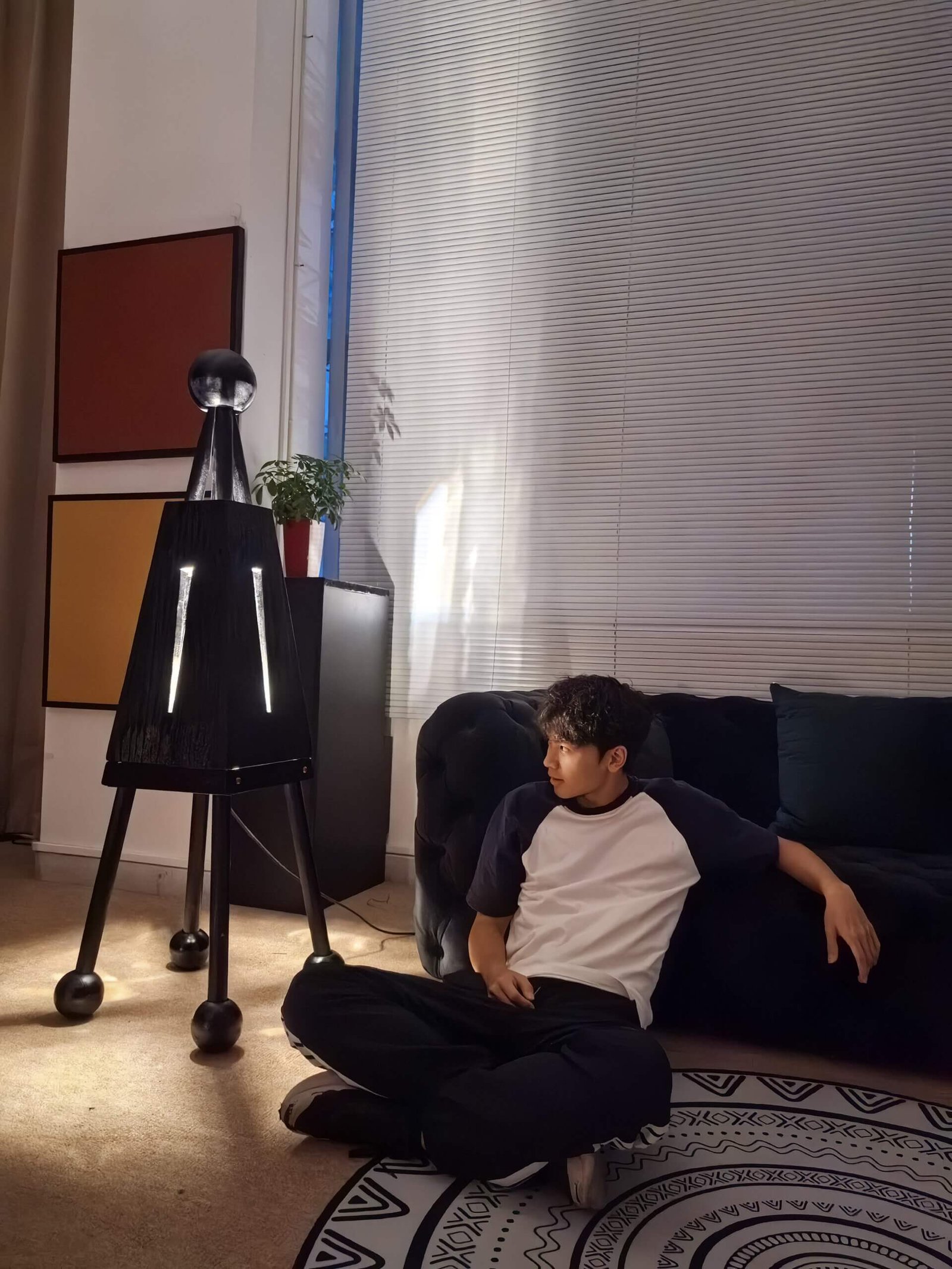 This artistic floor lamp, named Demonlet, is a handmade product crafted from natural solid wood. Its design evokes a European and American medieval style. It is a product of FLOWLIGHT DESIGN INC. and can be found at flowlightdesign.com.